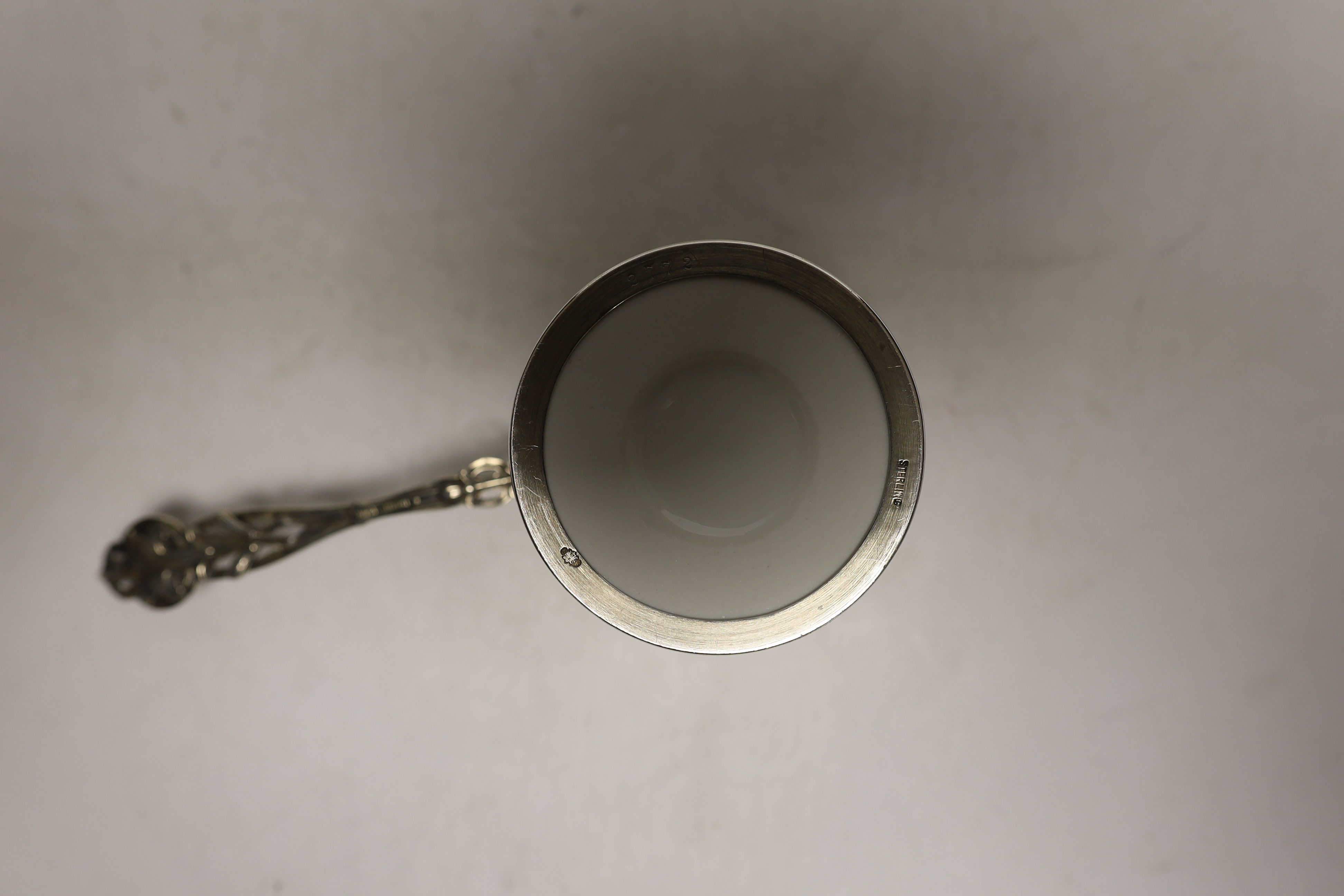A set of six American sterling mounted handled ceramic soufflé holders, length 17cm.